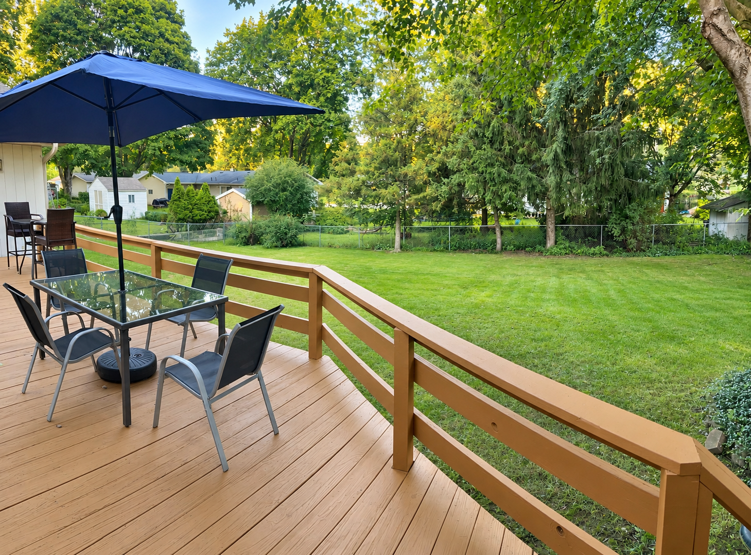 Deck overlooking Sugar Maple Home's green backyard