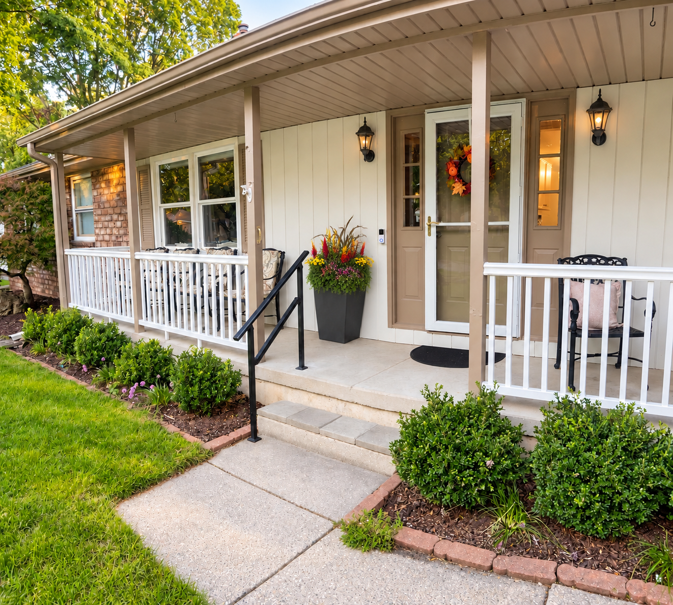 Front entrance of Sugar Maple Home with a welcoming porch and colorful flowers